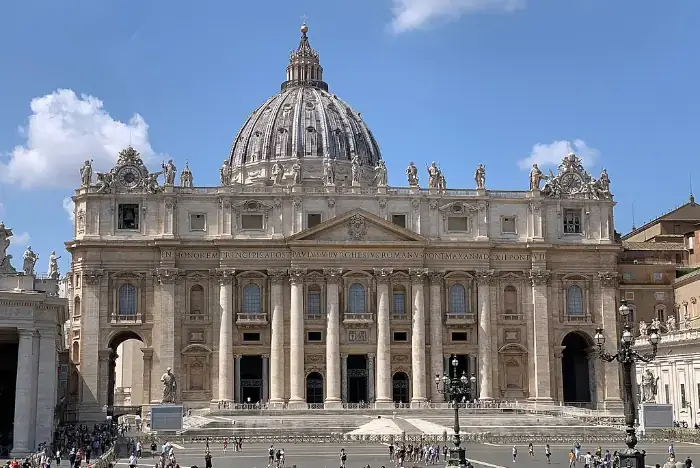Petersdom im Vatikan bei Tag mit vollständiger Fassade und hellem Himmel.